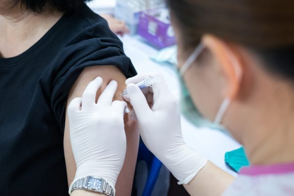 woman giving the Covid vaccine