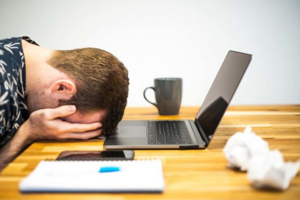 man tired at his laptop