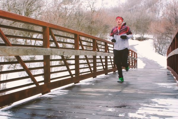 Person running on a bridge