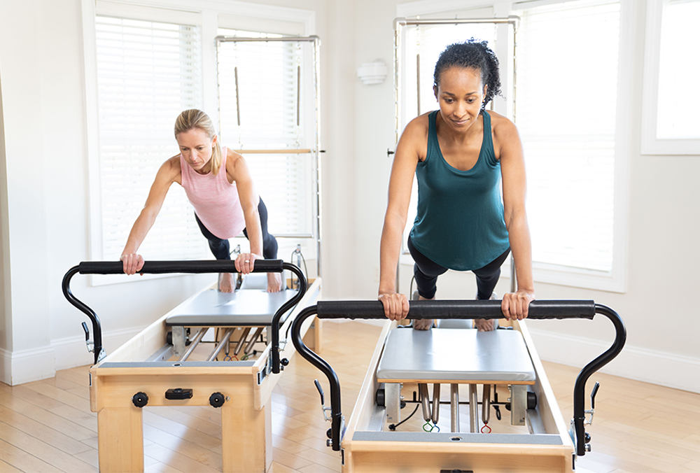 two women on a reformer pilates