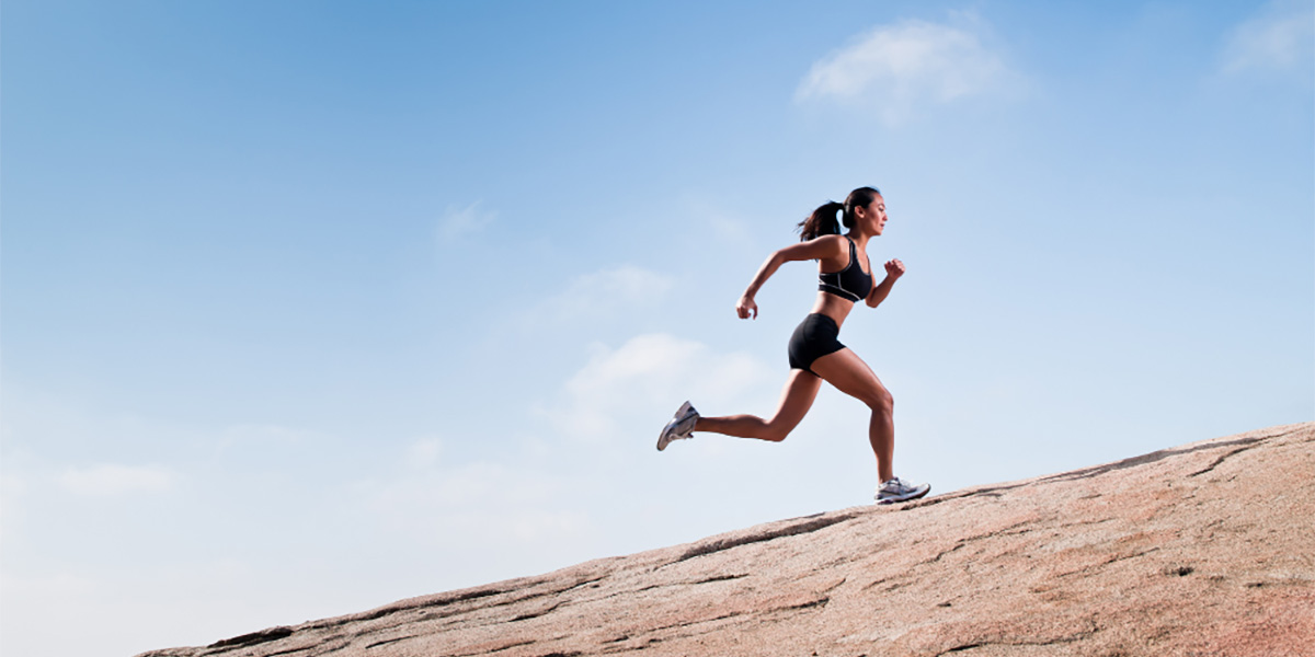 woman running up a hill