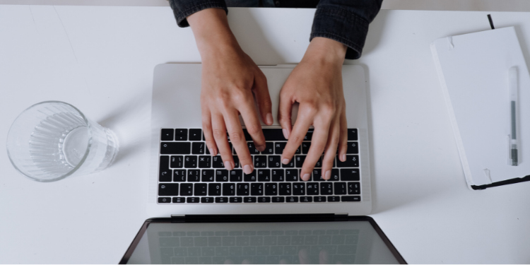 woman typing on a laptop