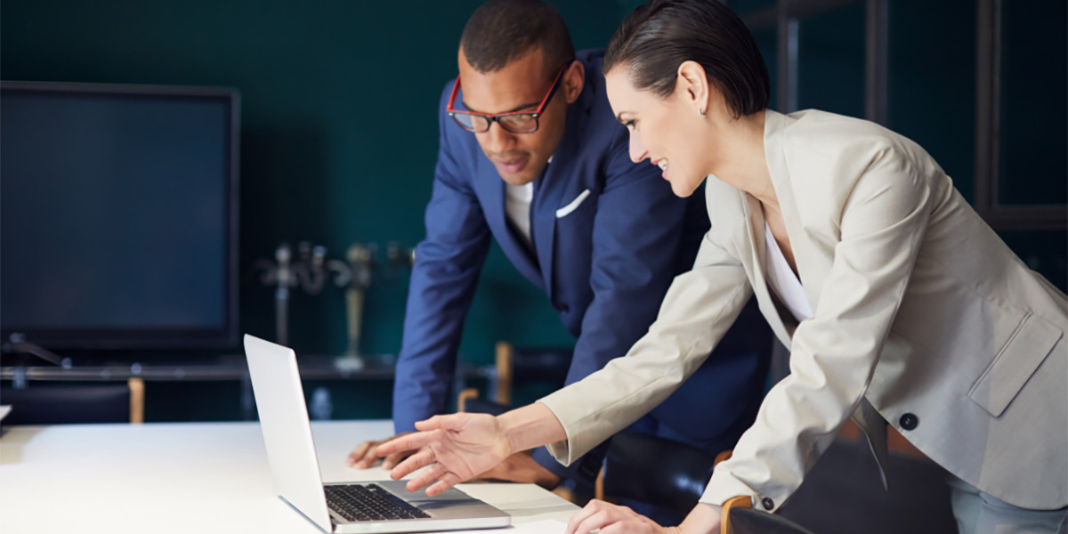 two business people looking at a laptop