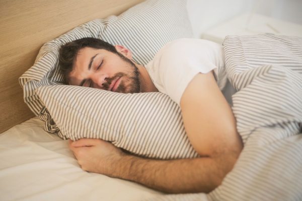 man sleeping in bed