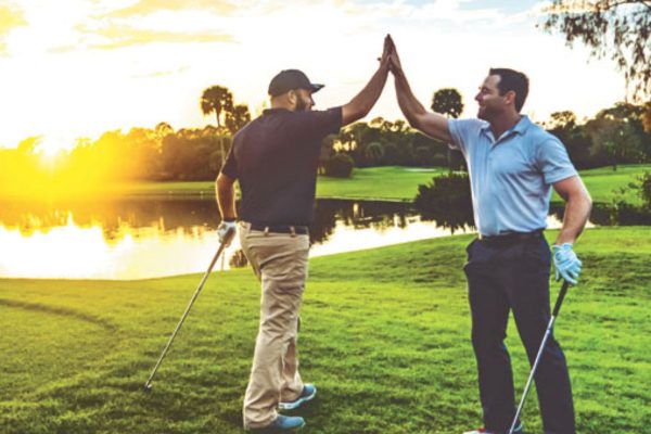 golfers giving each other a high five