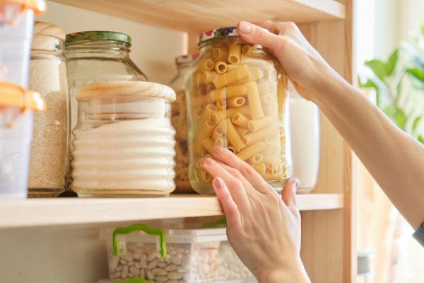 woman stocking pantry staples