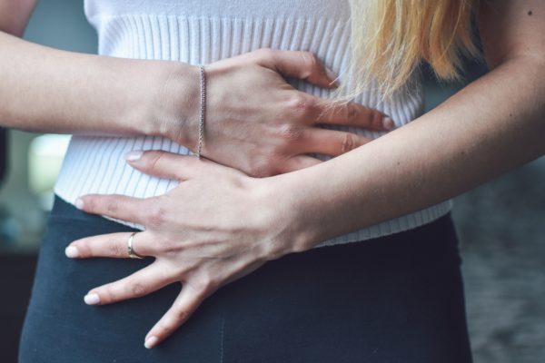 woman holding her stomach