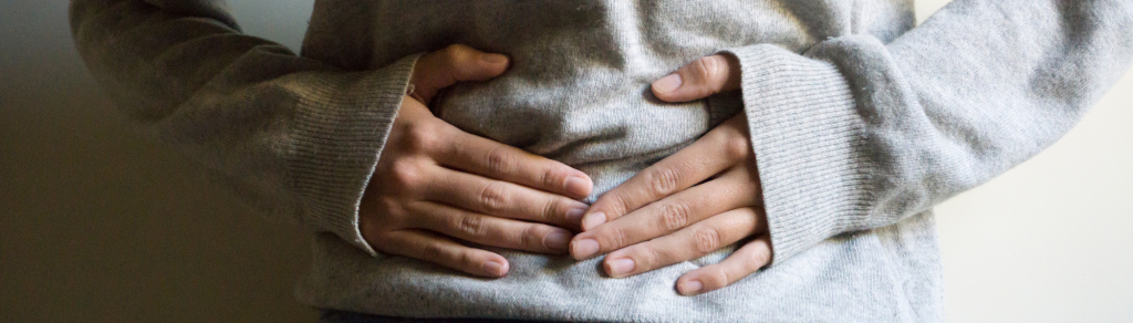 person with their hands on their stomach