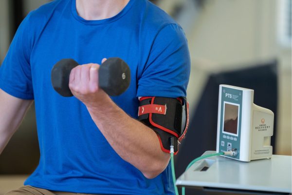 Man using blood flow restriction cuffs